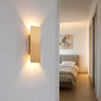 Modern minimalist LED wall lamp in a styled bedroom corridor