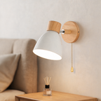Wooden nordic macaron wall sconce above a bedside table